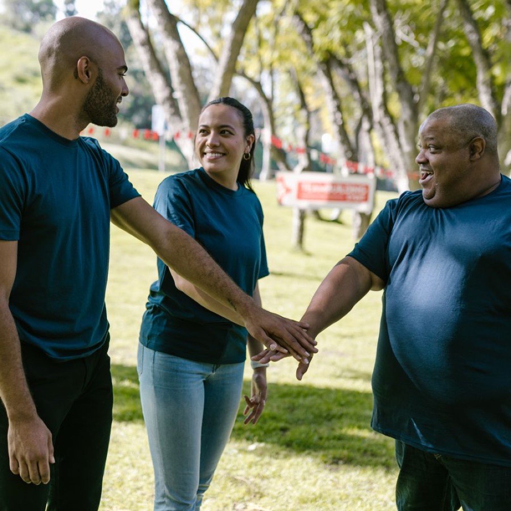 A diverse team celebrating together outdoors