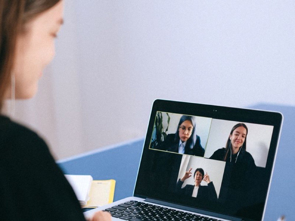 A video call with team members on a laptop